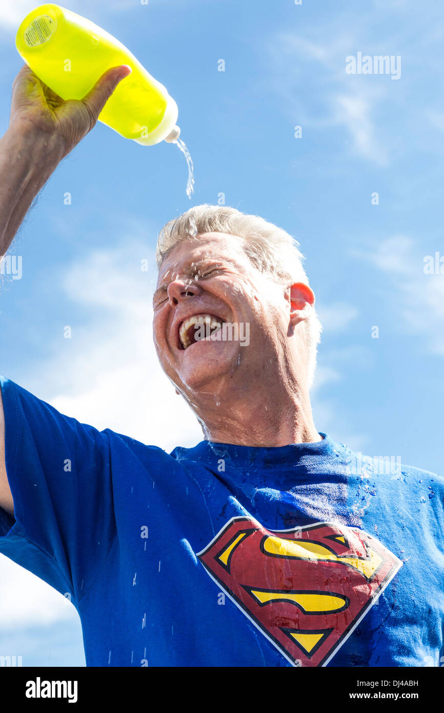 https://c8.alamy.com/comp/DJ4ABH/senior-man-wearing-superman-t-shirt-pouring-water-over-his-face-to-DJ4ABH.jpg