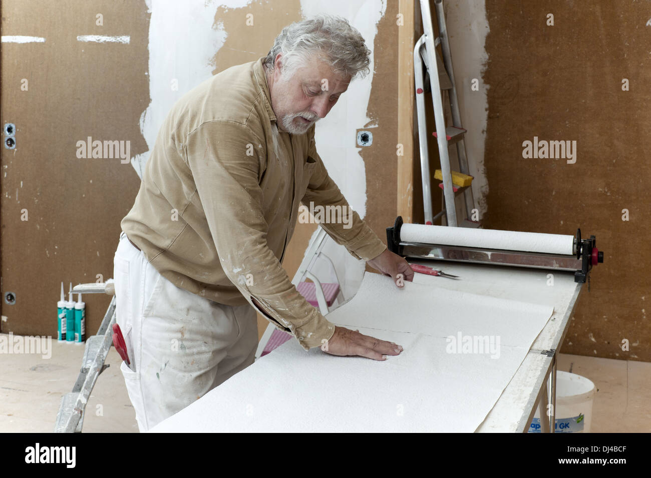 Painters working on a trestle table Stock Photo