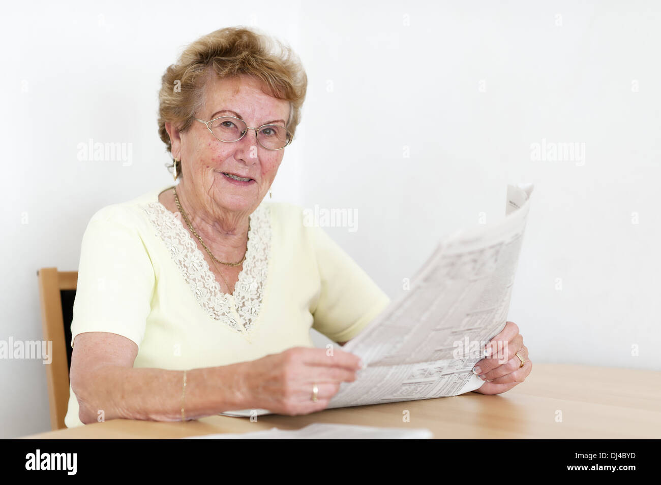 friendly elderly woman with newspaper Stock Photo