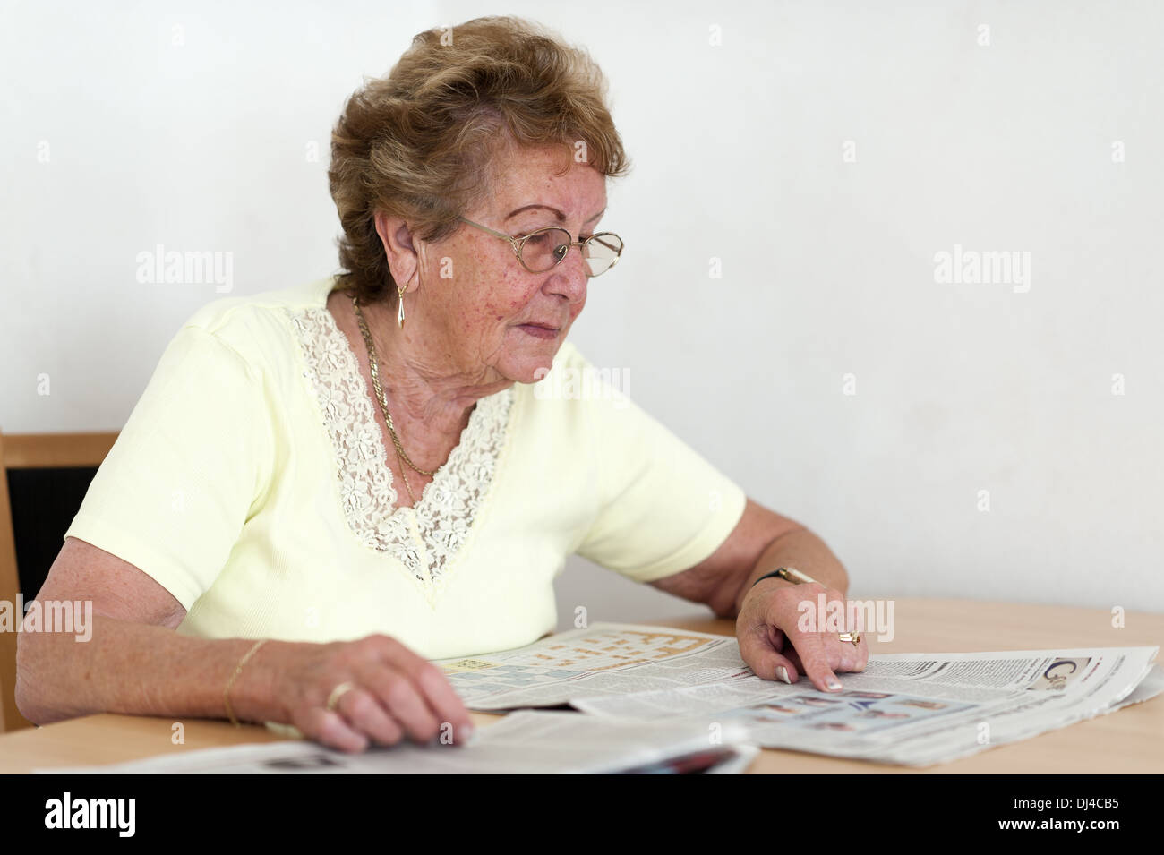 Senior interested in reading a newspaper Stock Photo