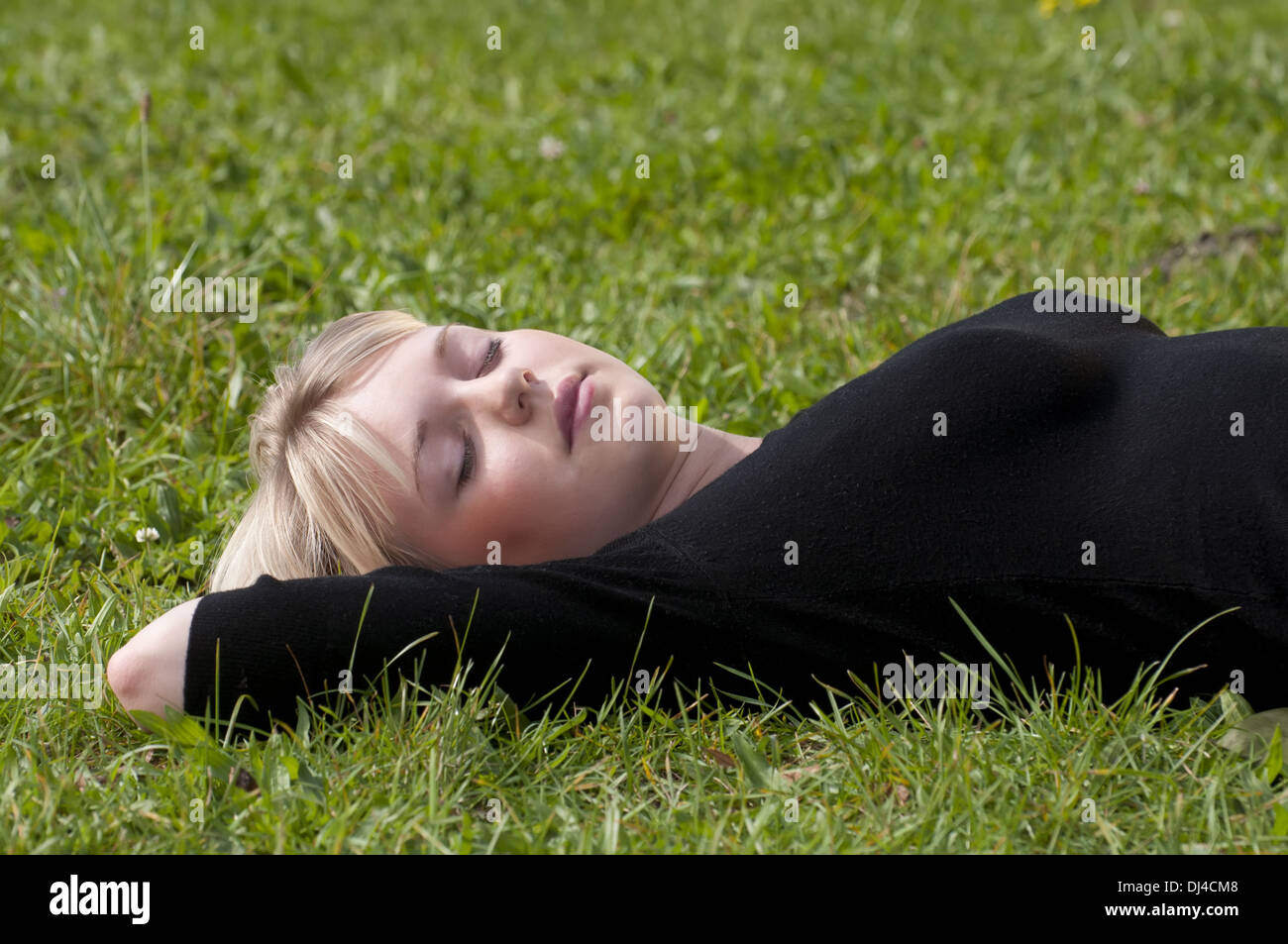 young woman lying on a meadow Stock Photo
