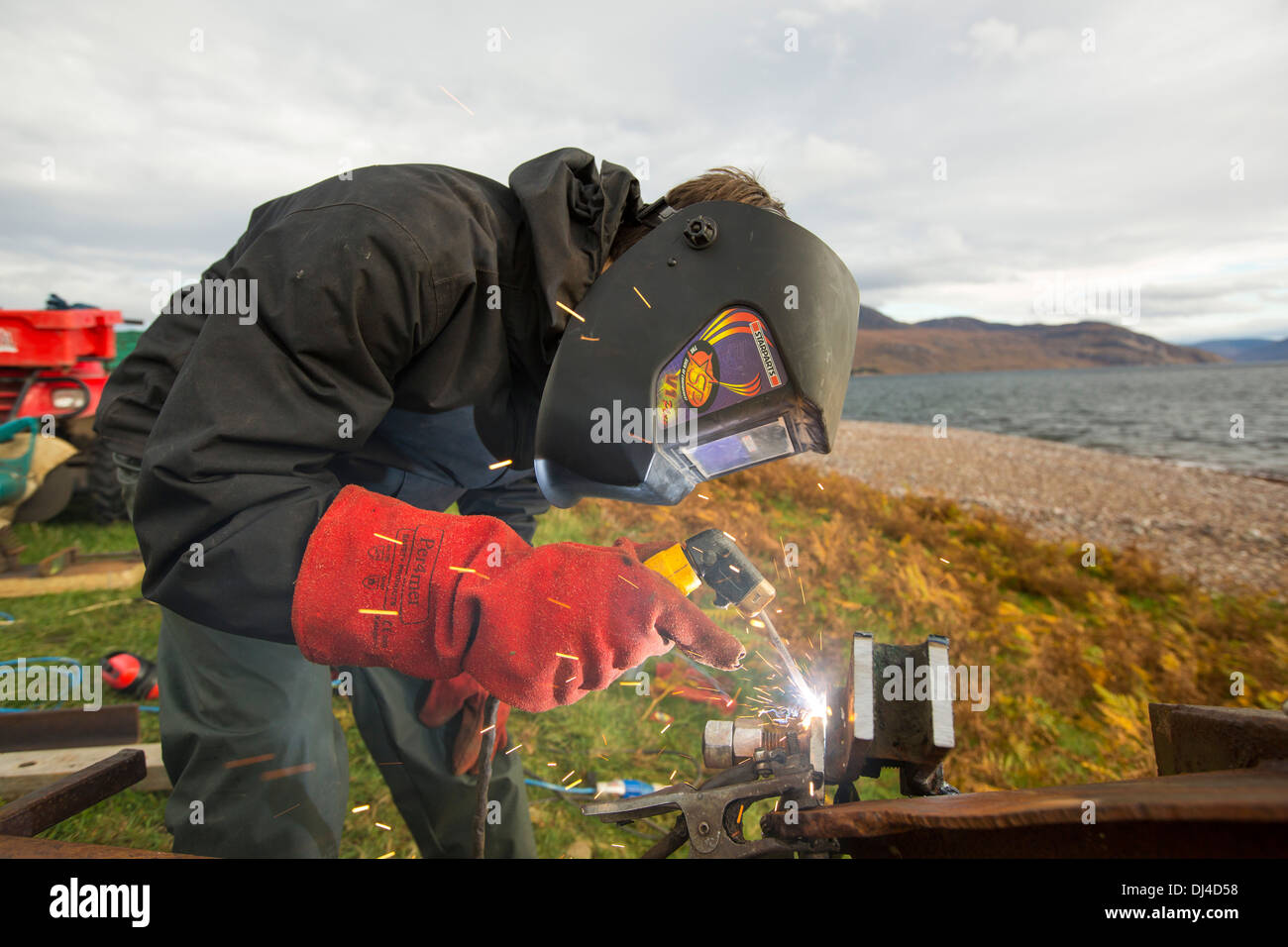 Hugh Piggott doing maintenance on his home made wind turbines in Scoraig, in NW Scotland, a remote off grid, communitiy, UK Stock Photo