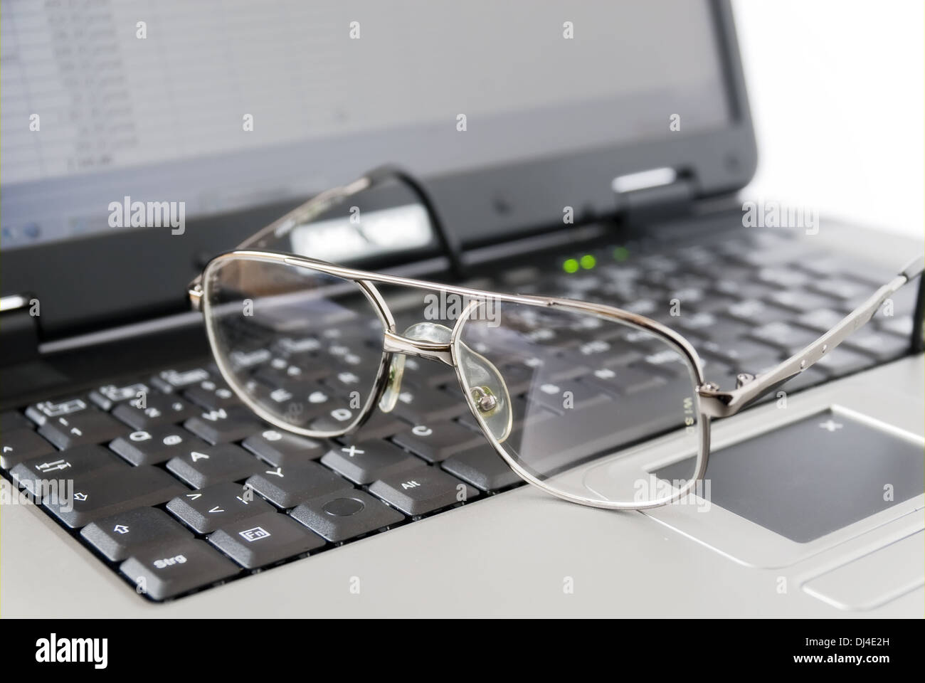 Glasses are on a laptop Stock Photo