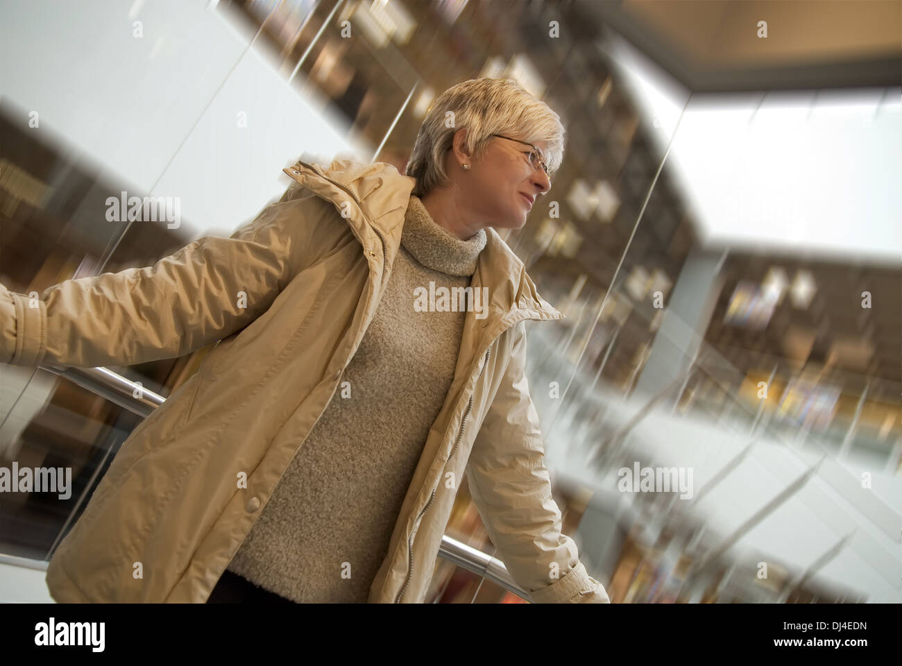 Woman, 50 plus, in the elevator Stock Photo