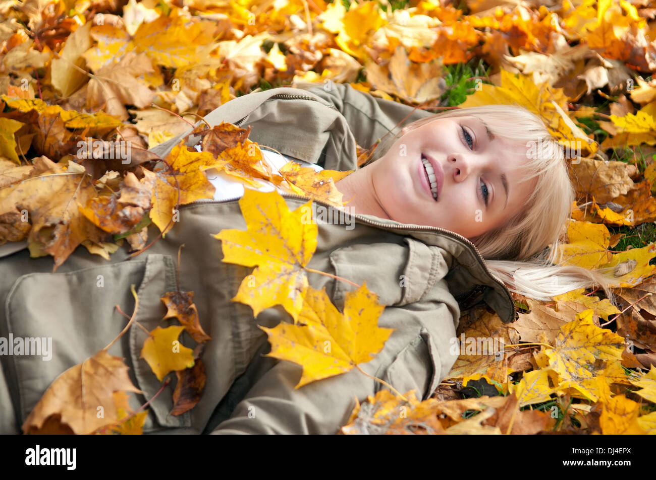young woman lying in autumn leaves Stock Photo - Alamy