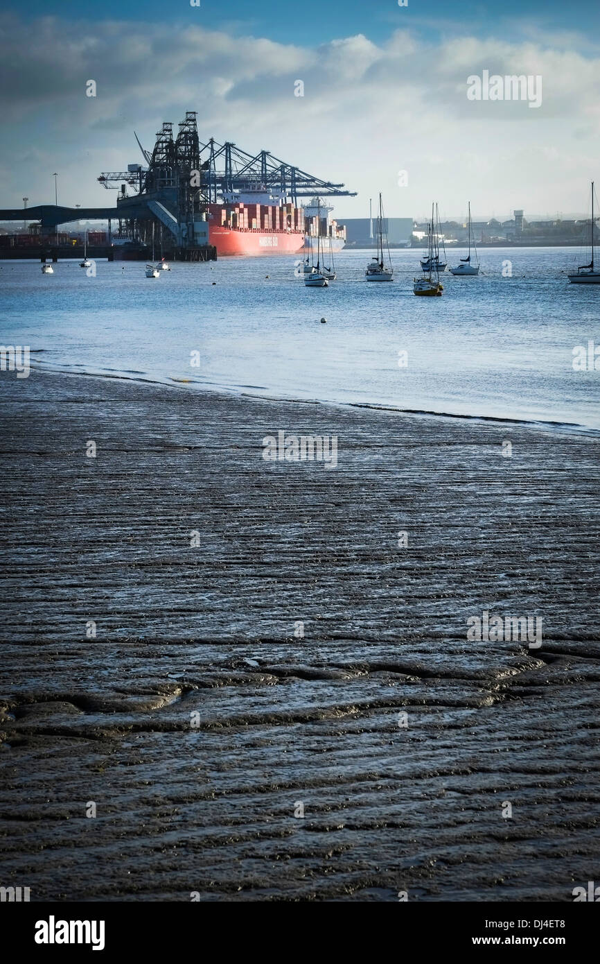 The foreshore of the River Thames with Tilbury Docks in the background Stock Photo