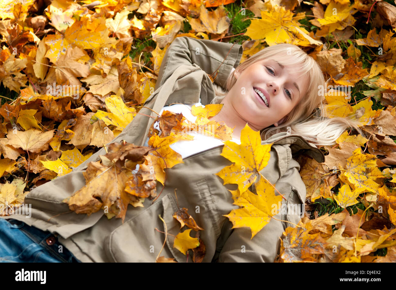 young woman lying in autumn leaves Stock Photo - Alamy