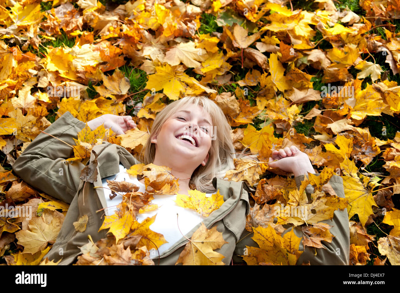 young woman lying in autumn leaves Stock Photo - Alamy