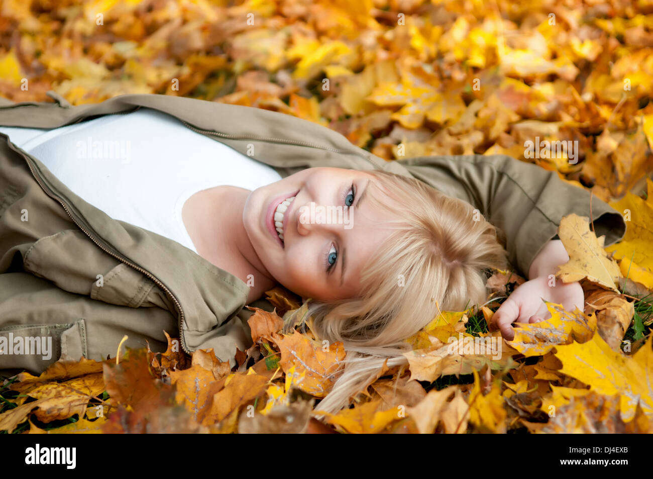 young woman lying in autumn leaves Stock Photo - Alamy