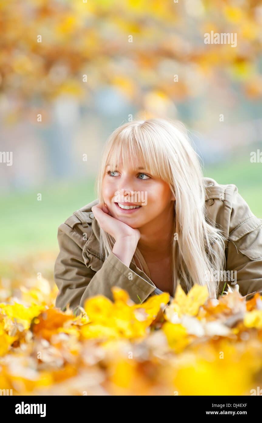 young woman lying in autumn leaves Stock Photo - Alamy
