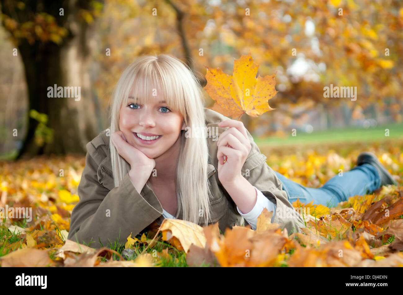 young woman lying in autumn leaves Stock Photo - Alamy