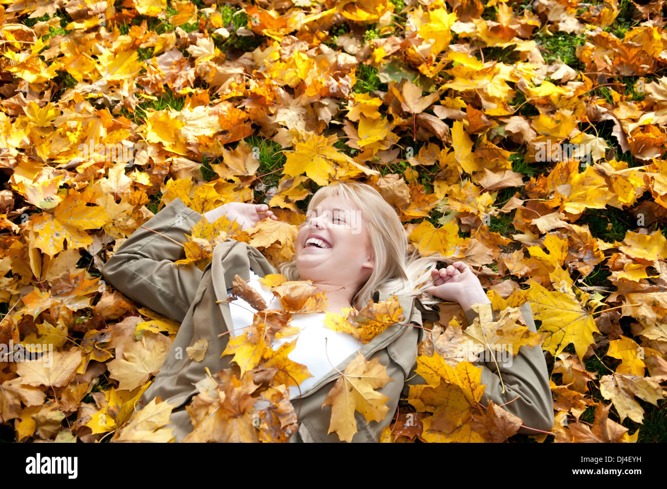 young woman lying in autumn leaves Stock Photo - Alamy