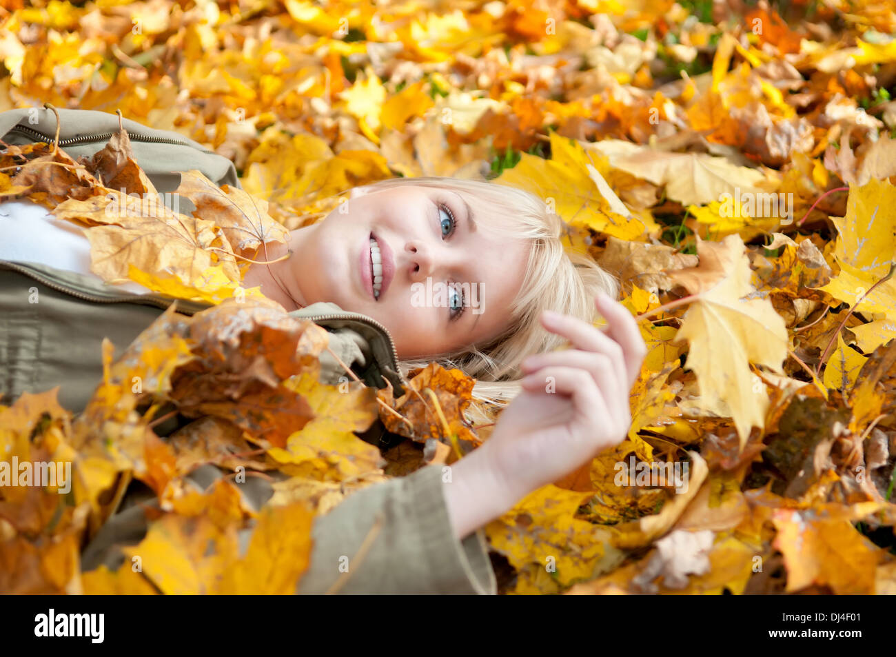 young woman lying in autumn leaves Stock Photo - Alamy