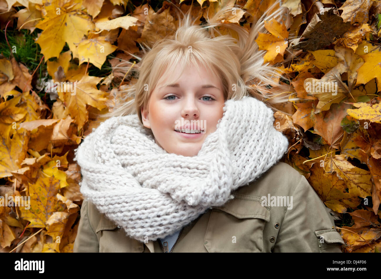 young woman lying in autumn leaves Stock Photo - Alamy