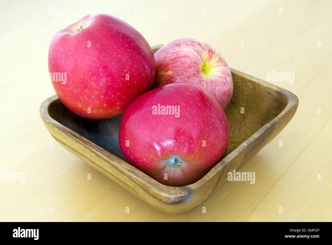 3 apples in a wooden bowl Stock Photo
