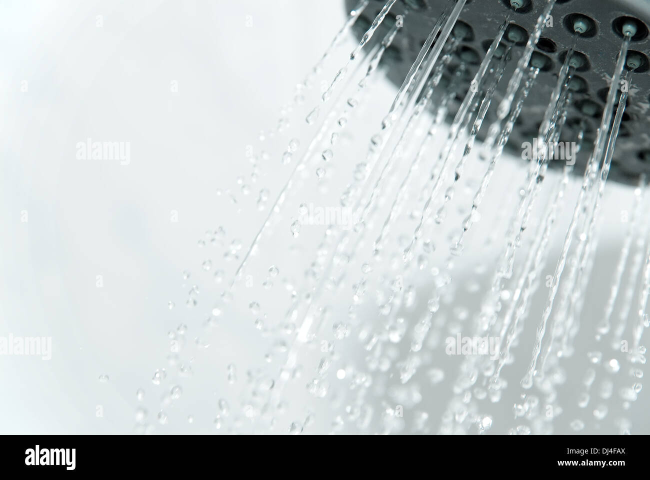 Shower head with water jets exiting Stock Photo