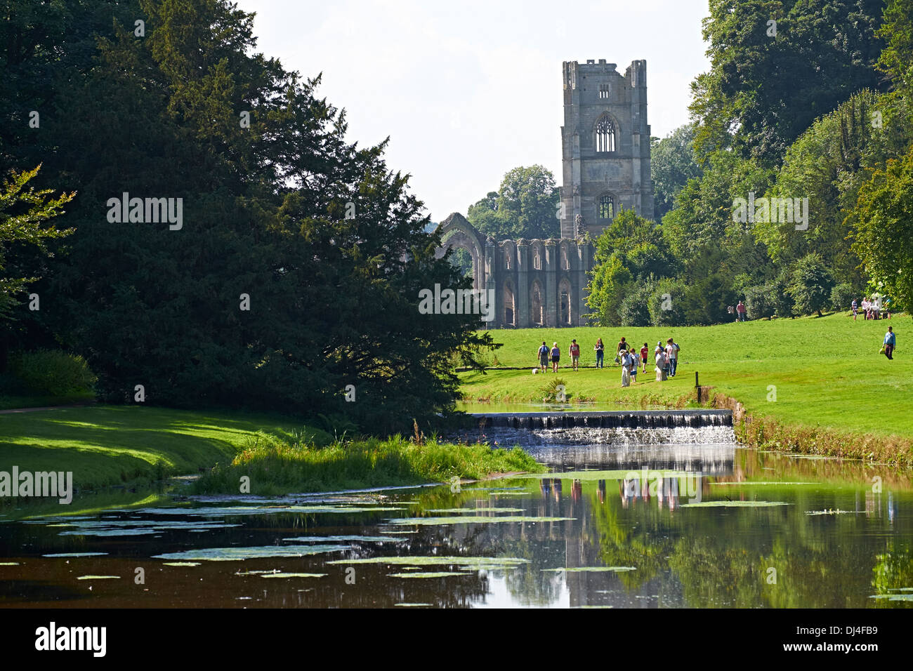 Exterior views of Fountains Abbey reflected in the river. North