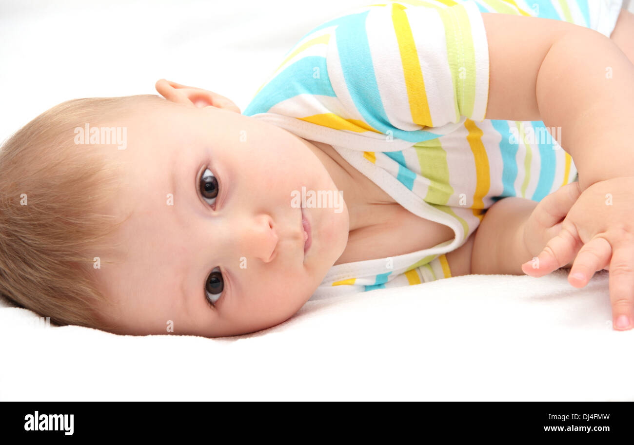 baby lying in bed Stock Photo