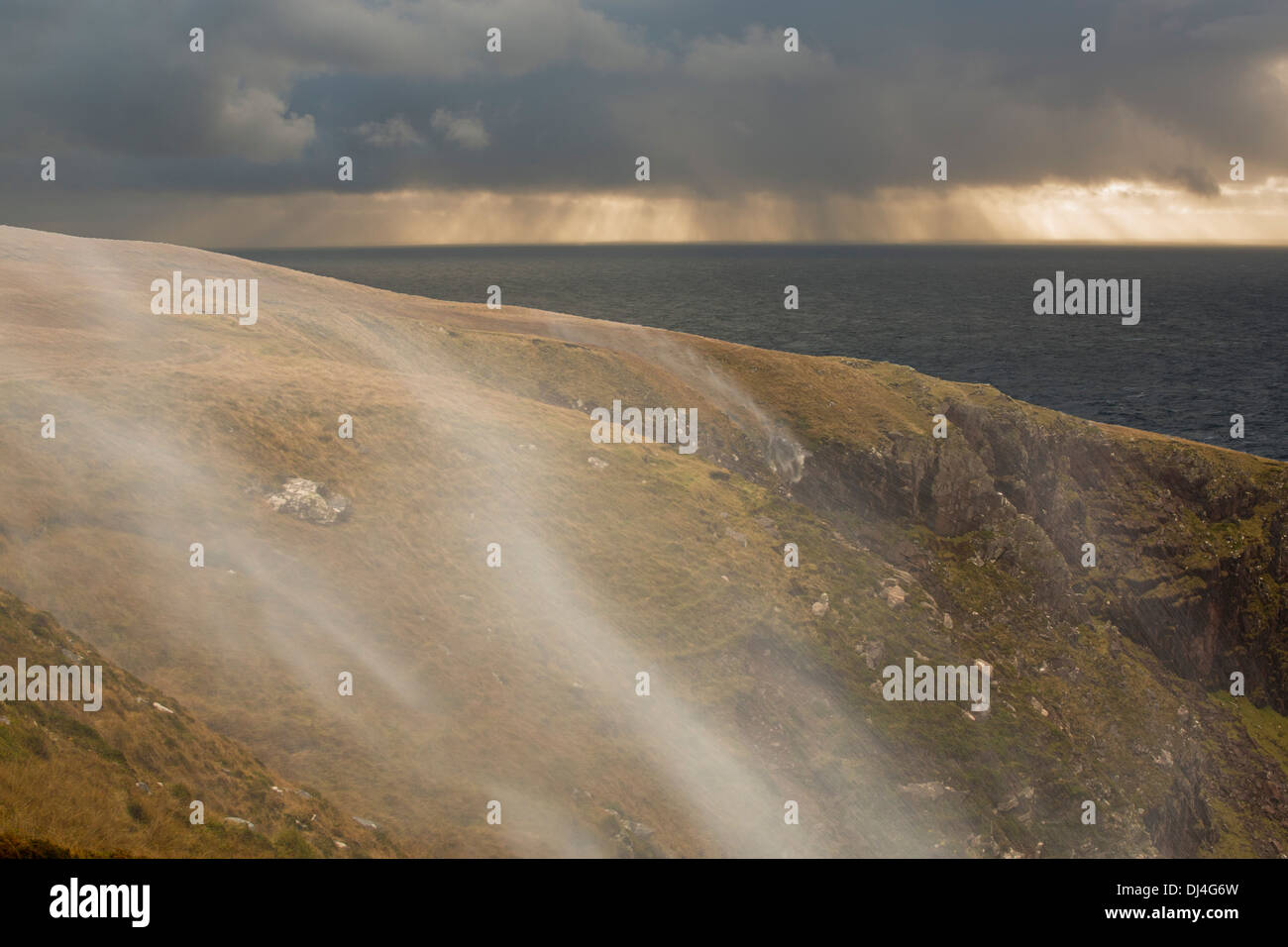 Moorland stream waterfalls on the coast at Stoer in Assynt, Scotland, UK, blowing uphill in storm force winds. Stock Photo