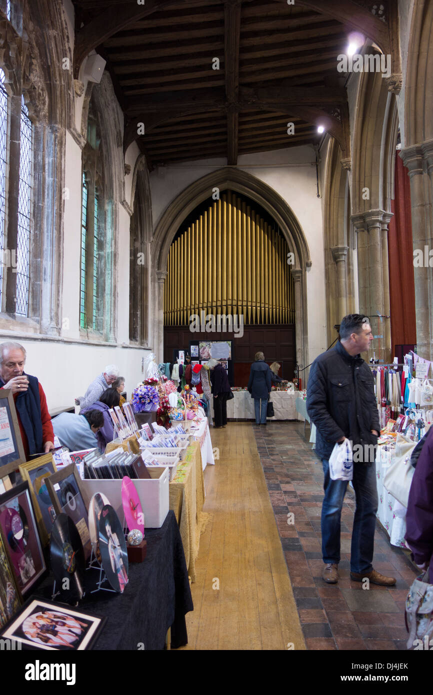 Deconsecrated church stallholders and visitors at a craft fair inside St Peter's church in