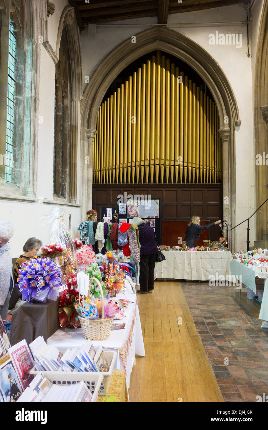 Deconsecrated church stallholders and visitors at a craft fair inside St Peter's church in