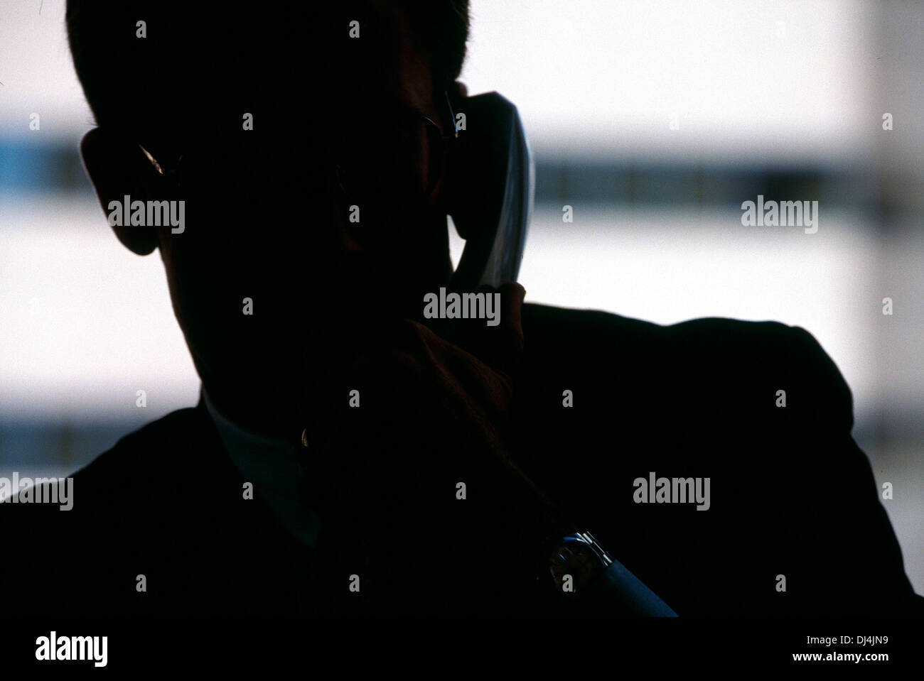 A silhouette of a man on phone Stock Photo