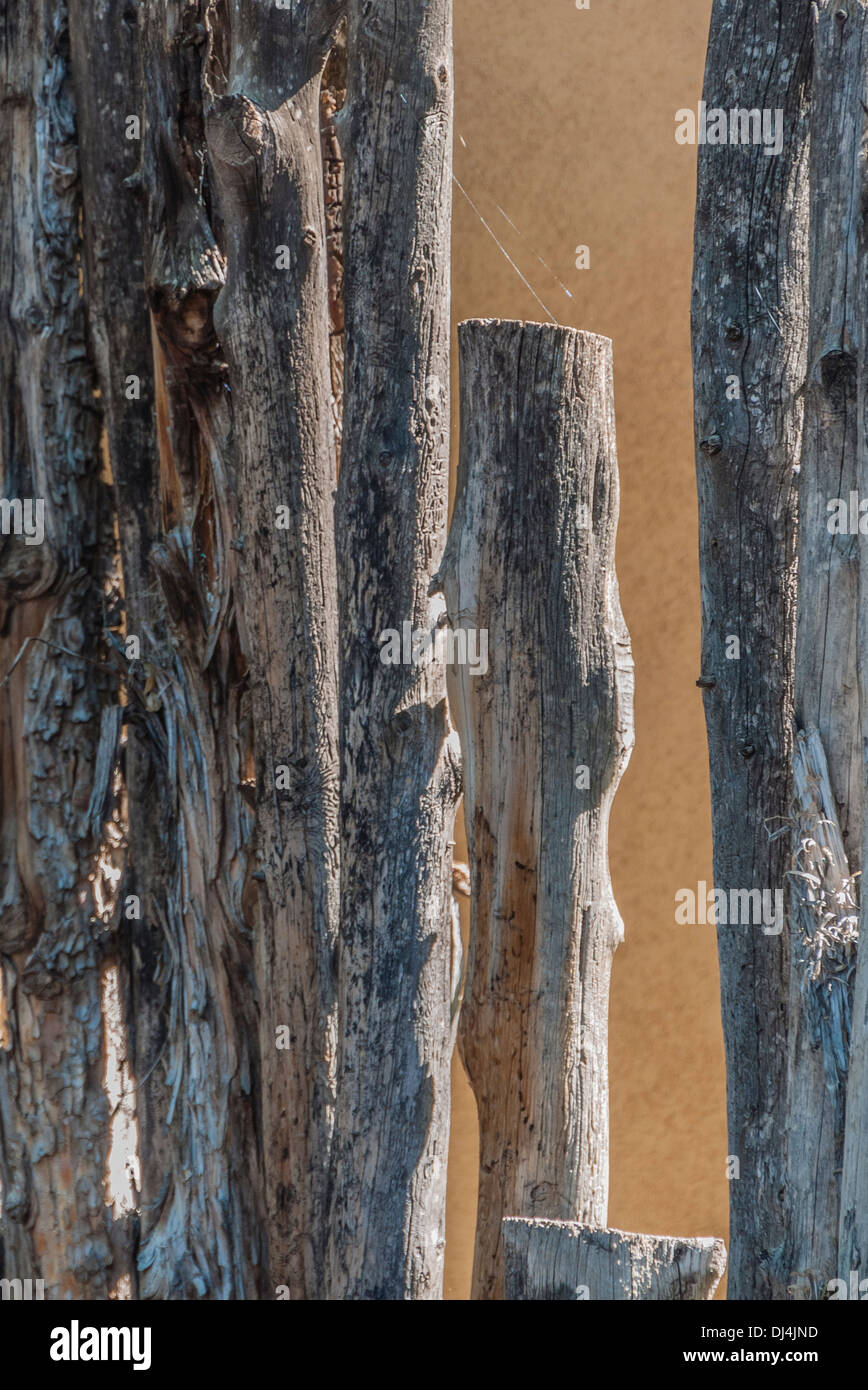 A close-up view of a traditional fence made of tree branches as is common in the state of New Mexico, USA. Stock Photo