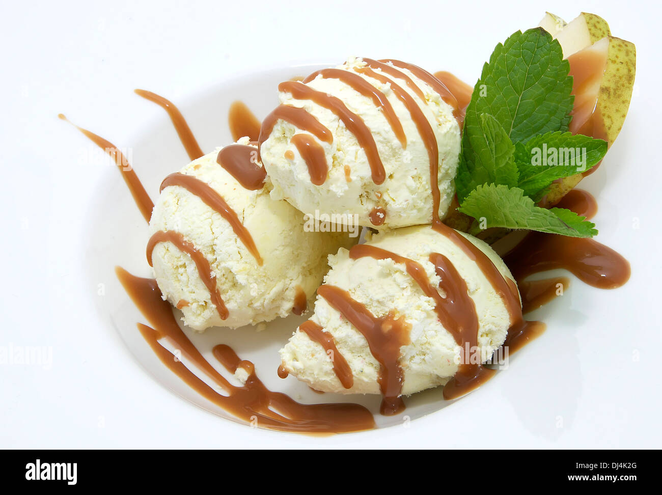 ice cream with caramel sauce and mint on a white background Stock Photo ...