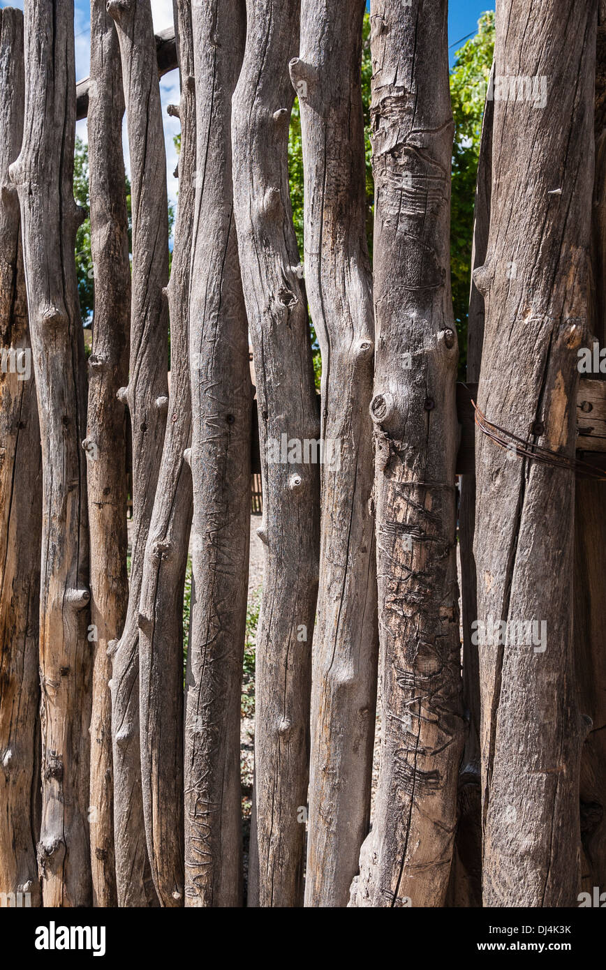 A closeup view of a traditional fence made of tree branches as is