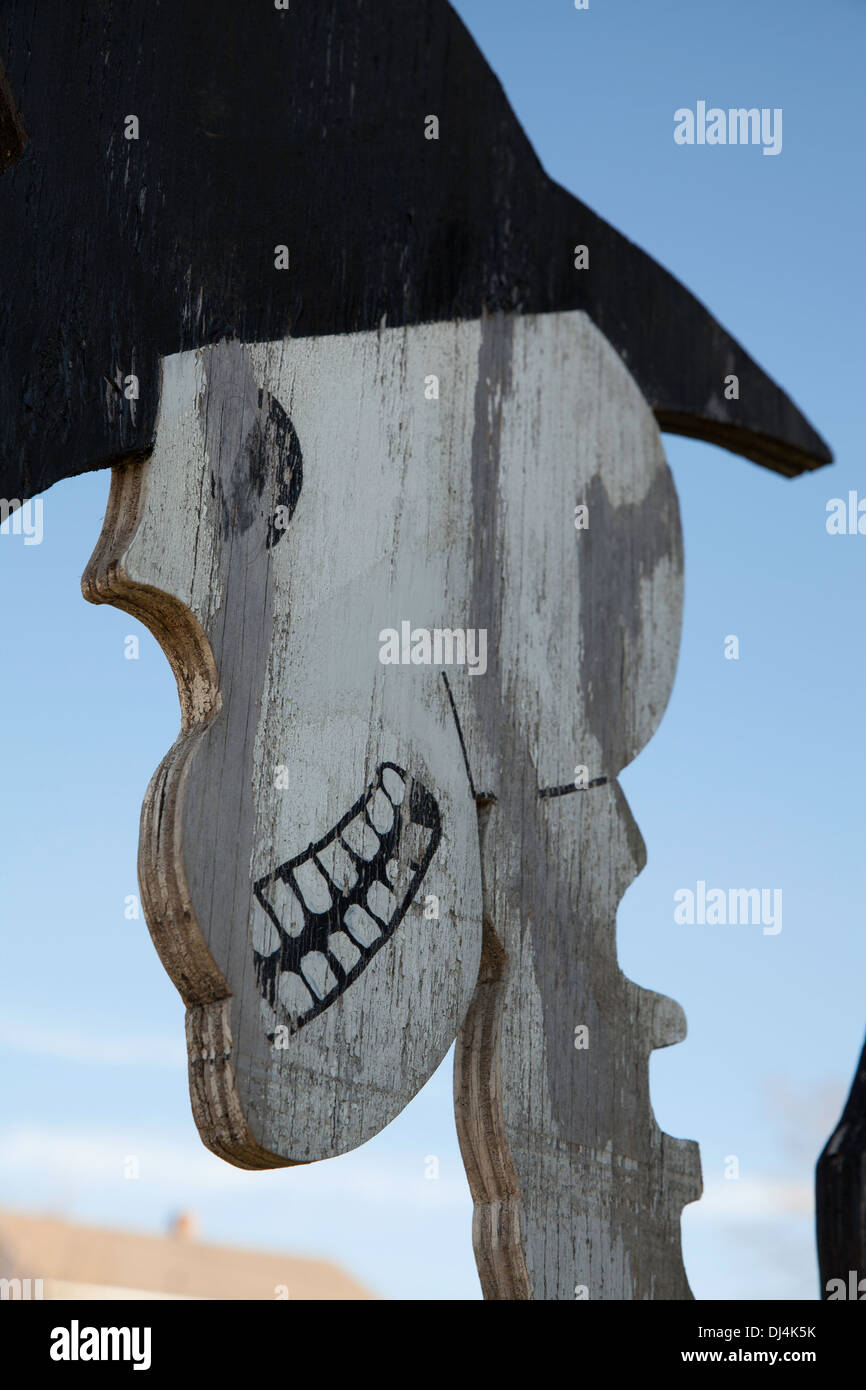 A wooden cutout of a skeleton cowboy is a  Halloween decoration at a roadside stand in the Massachusetts Berkshires. Stock Photo