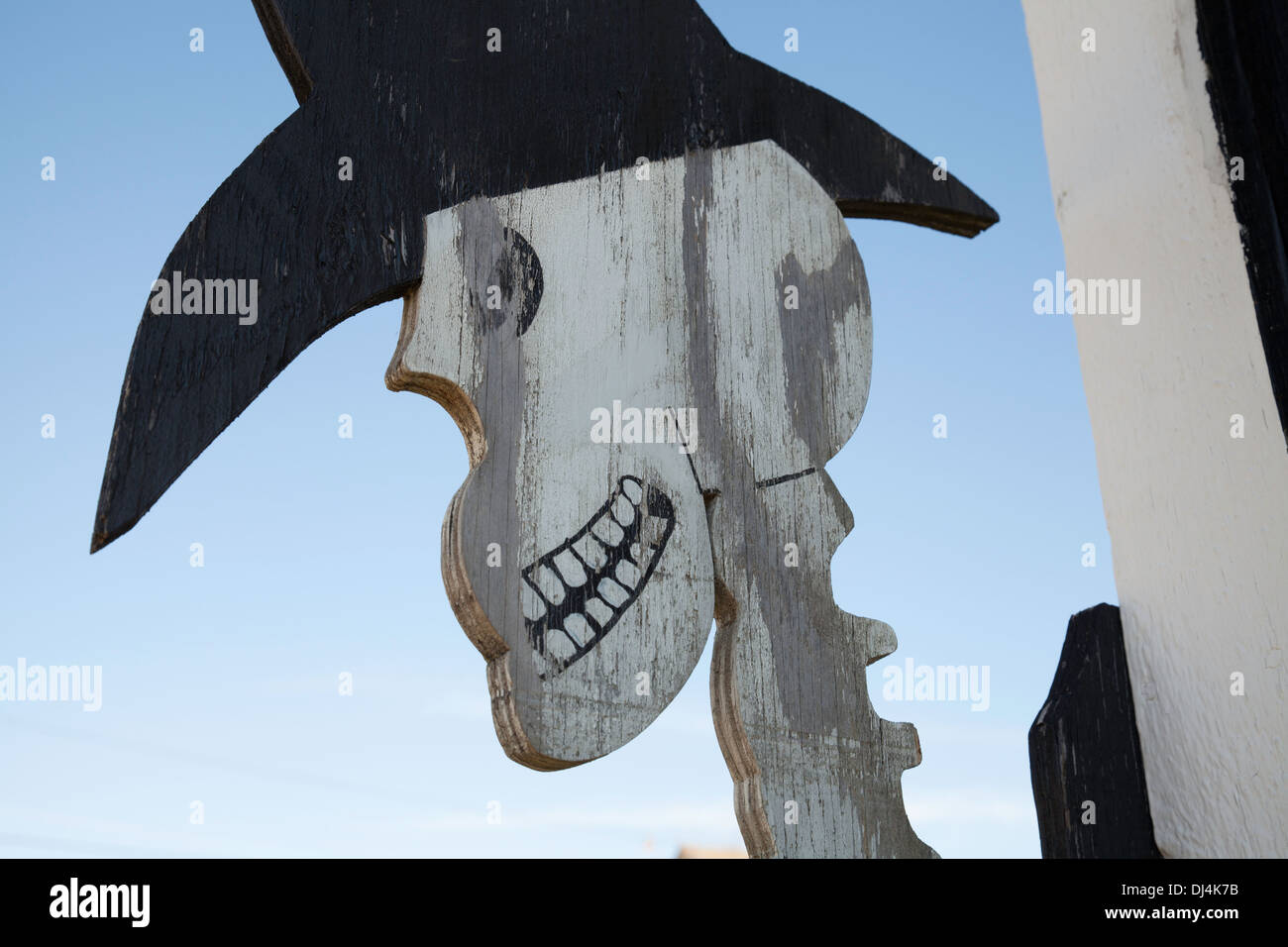 A wooden cutout of a skeleton cowboy is a  Halloween decoration at a roadside stand in the Massachusetts Berkshires. Stock Photo