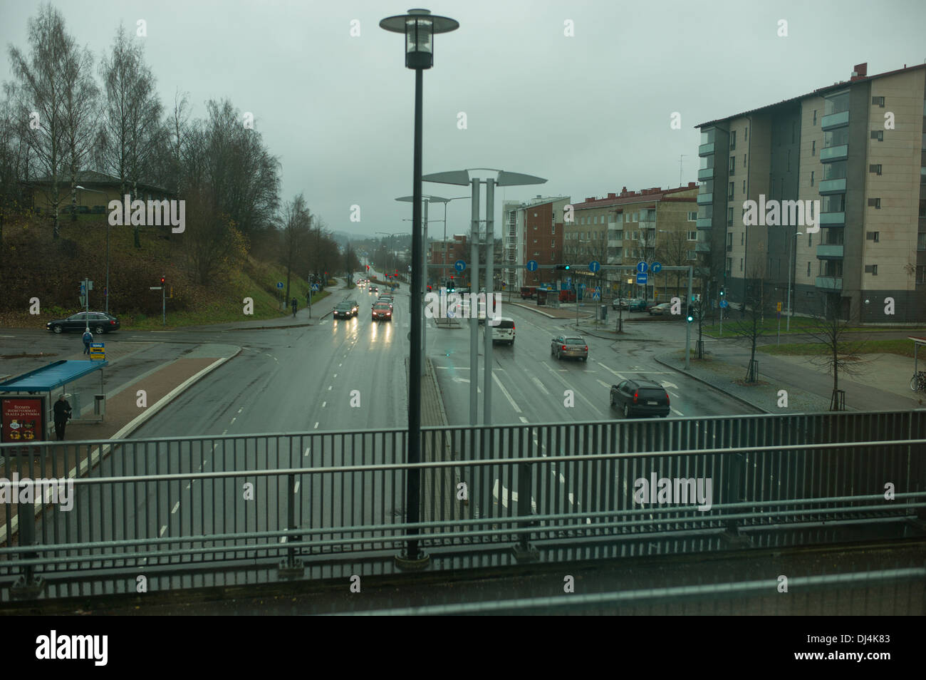 railway,bridge,train,Allegro,Finland,road,cars,cloudy,rain,railway station,house,building,people,city,town,urban, Stock Photo