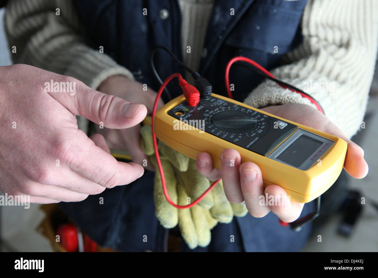 Apprentice using multimeter Stock Photo