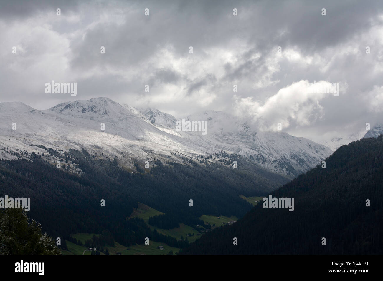 Shafts of sunlight and storm clouds passing over The Sertig Tal of The Landwasser Valley Davos Graubunden Switzerland Stock Photo