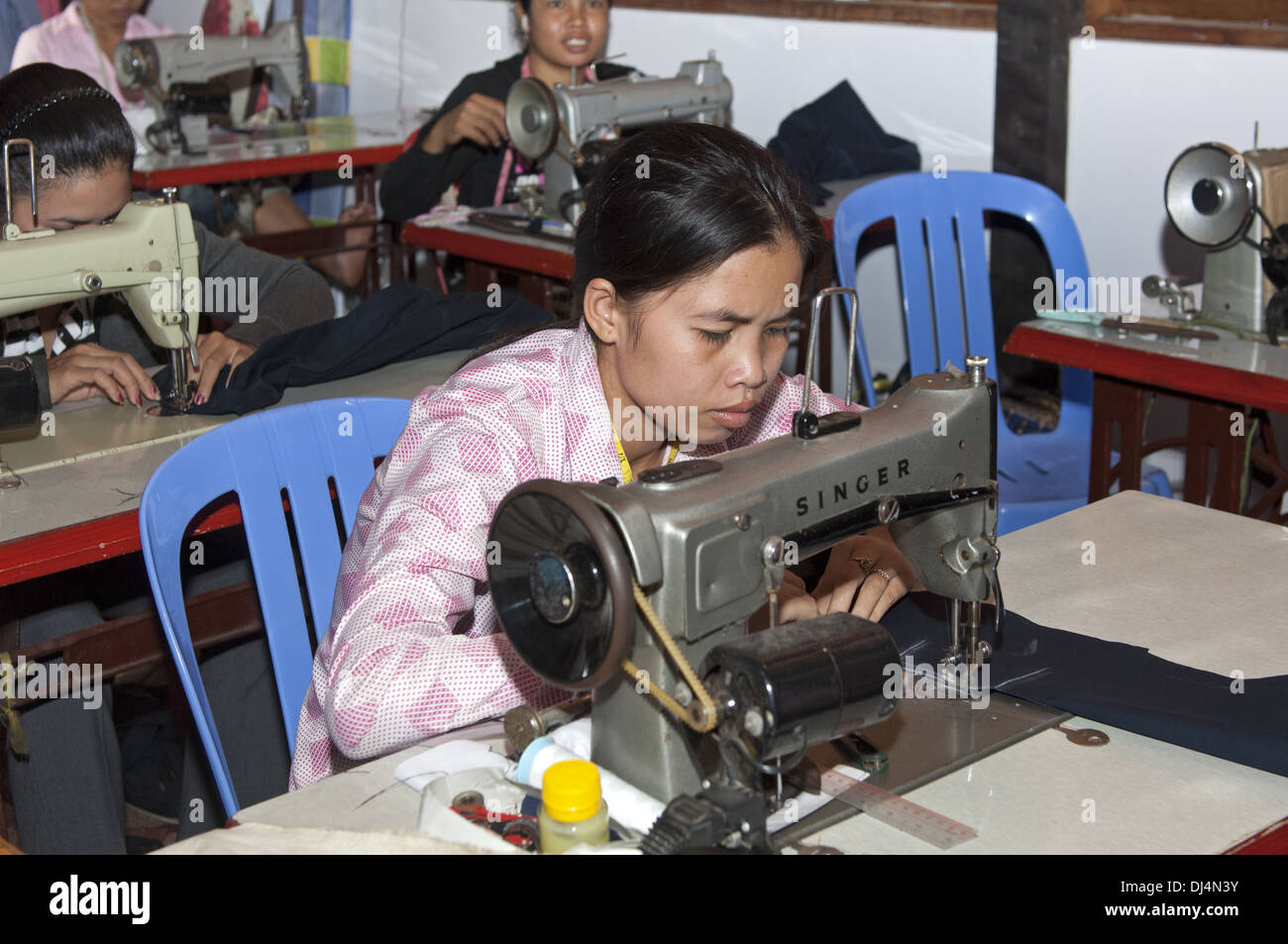 Sewing professional working in a tailor shop Stock Photo