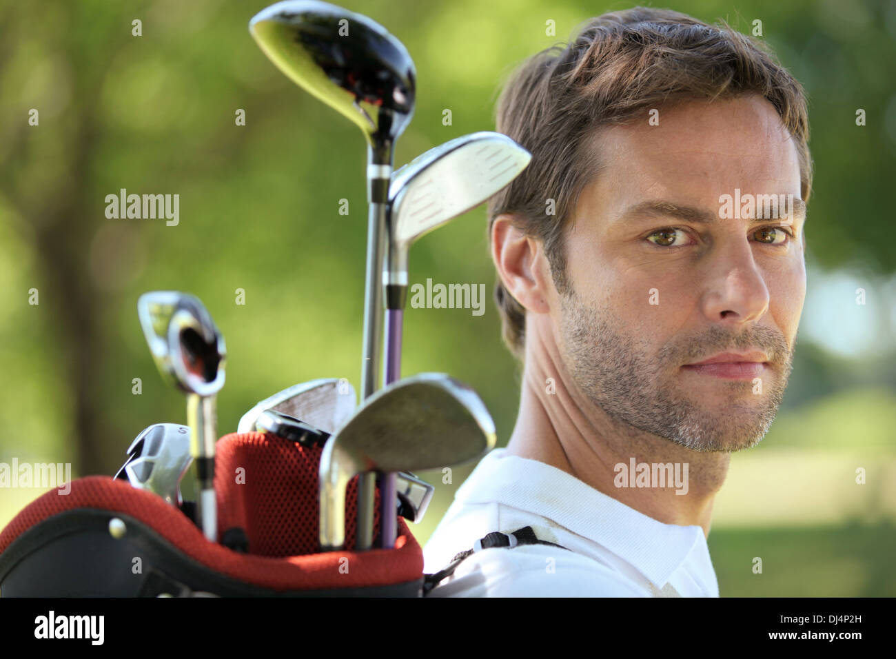 Man carrying golf bag Stock Photo Alamy