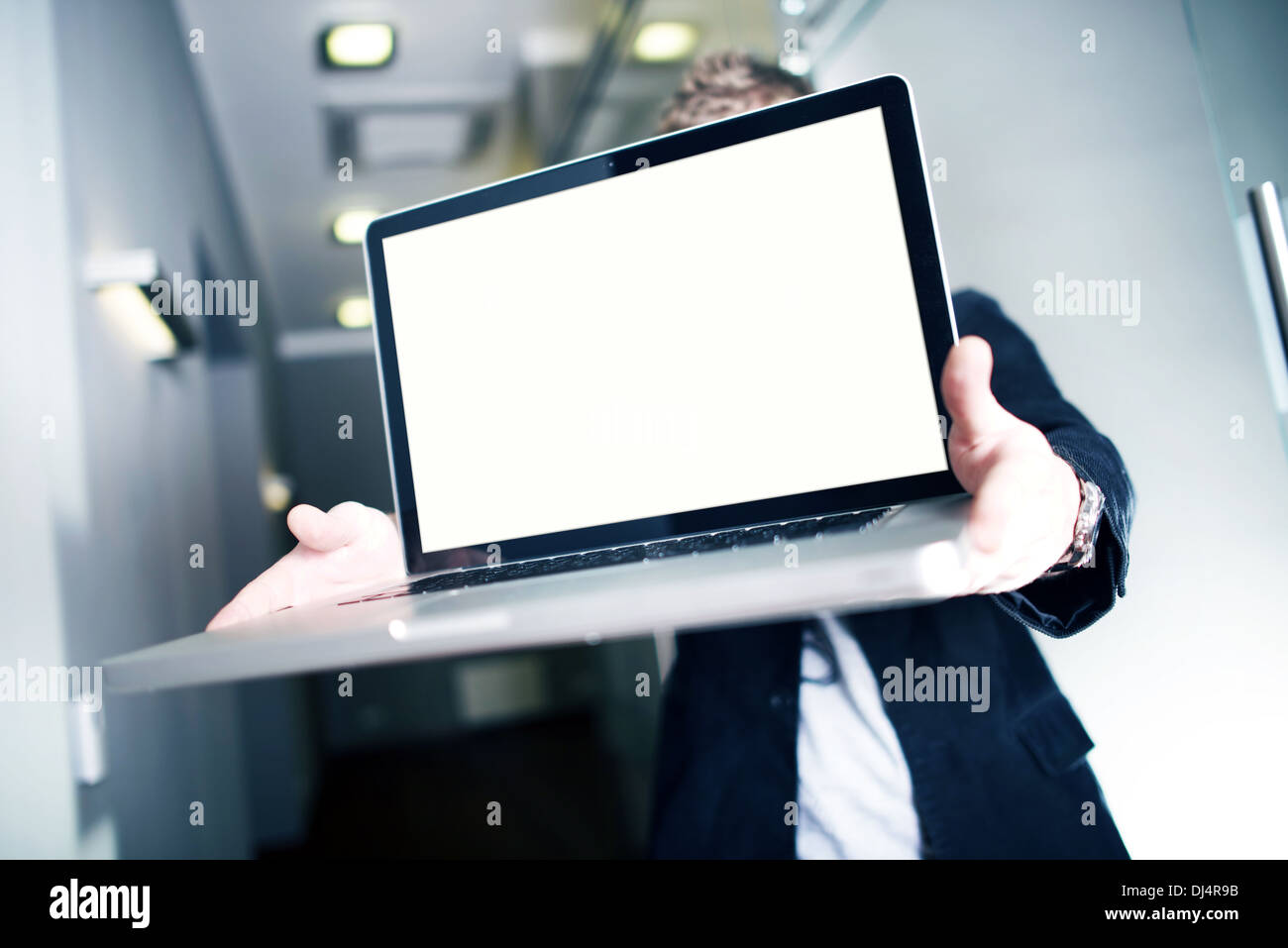 Website Delivery. Young Businessman Showing Website or Any Other Digital Project. Just Place your Content! Website, Stats, Desig Stock Photo