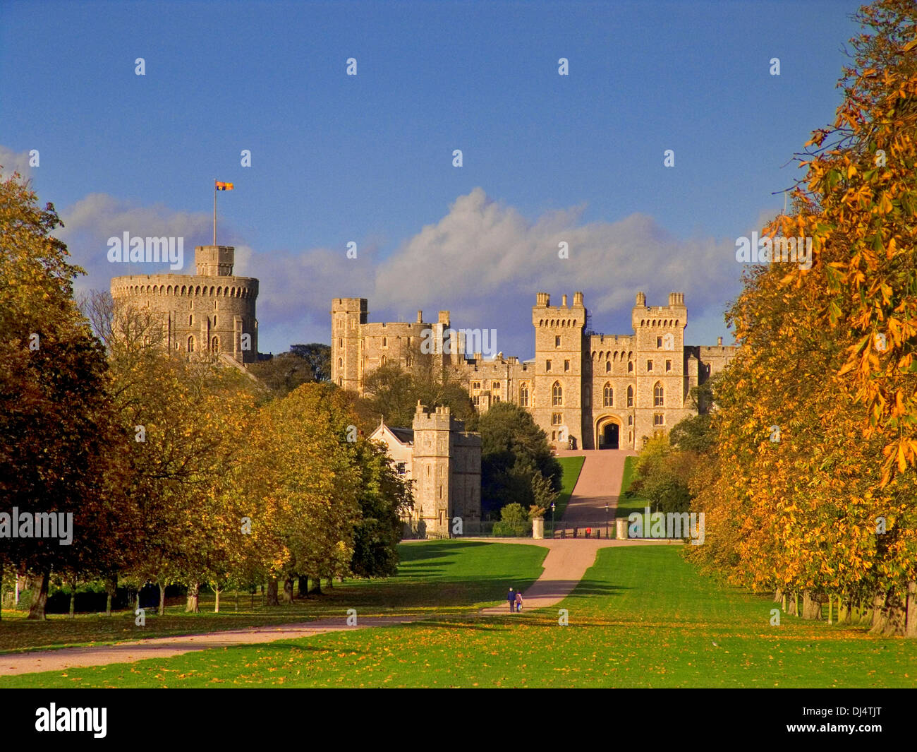Windsor Castle flying Royal Standard viewed down the Long Walk with walkers, in autumnal colour Berkshire UK Stock Photo