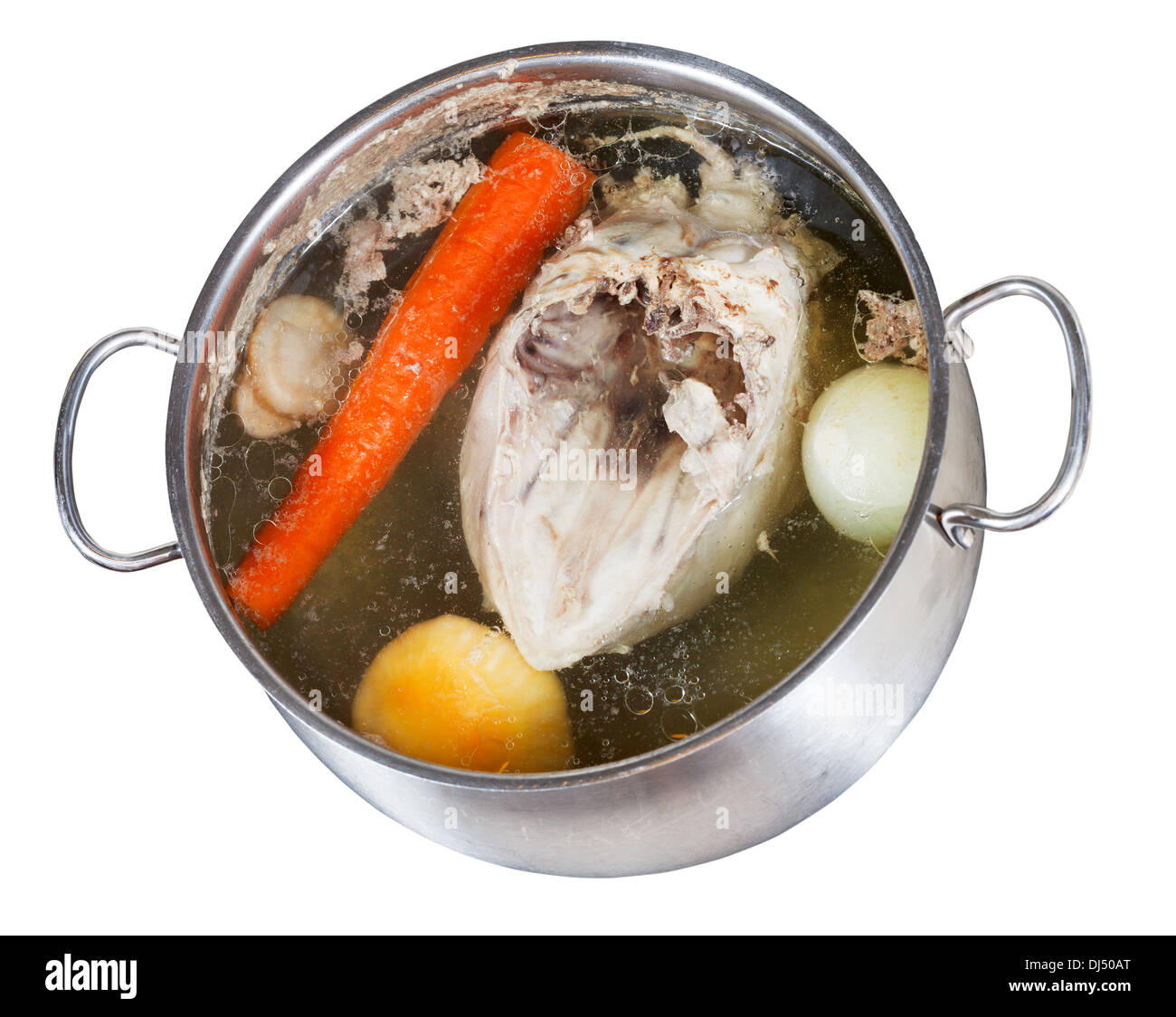 boiling of chicken broth with seasoning vegetables in steel pan isolated on white background Stock Photo
