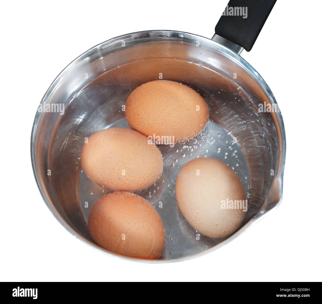 top view of boiling chicken eggs in metal pot on electric stove isolated on white background Stock Photo