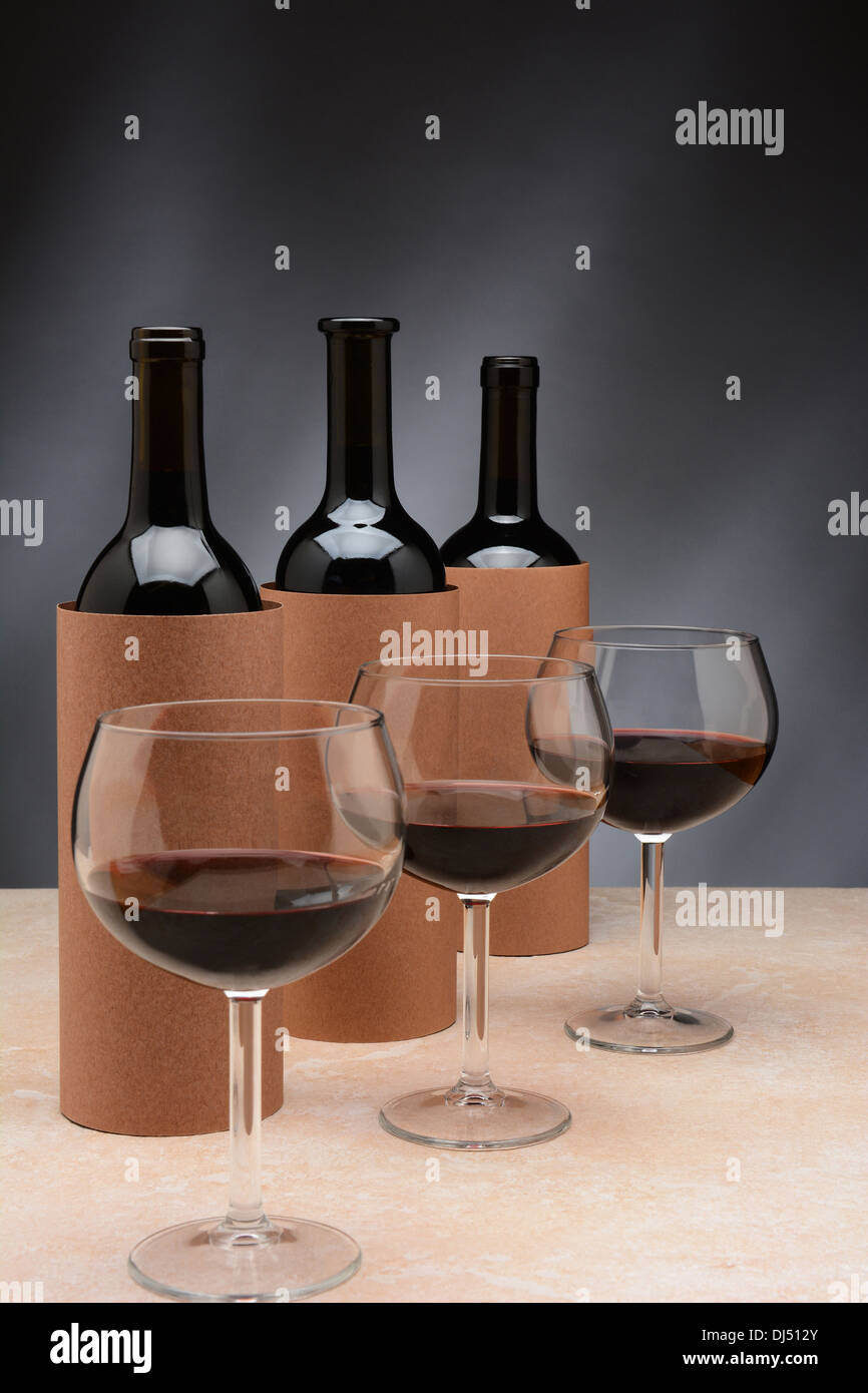 Three different wine bottles and wine glasses set up for a blind wine