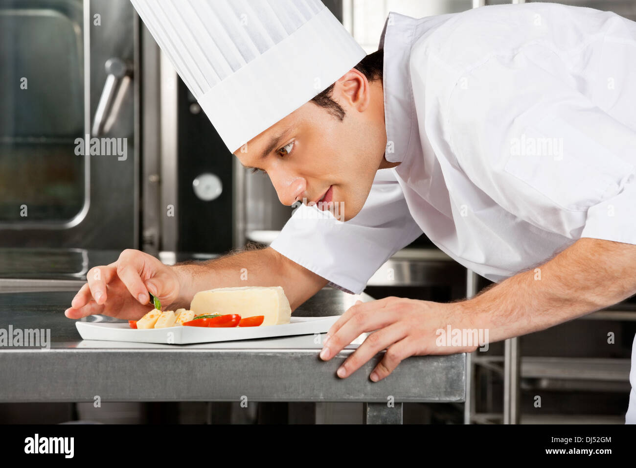 Chef Garnishing Dish Stock Photo