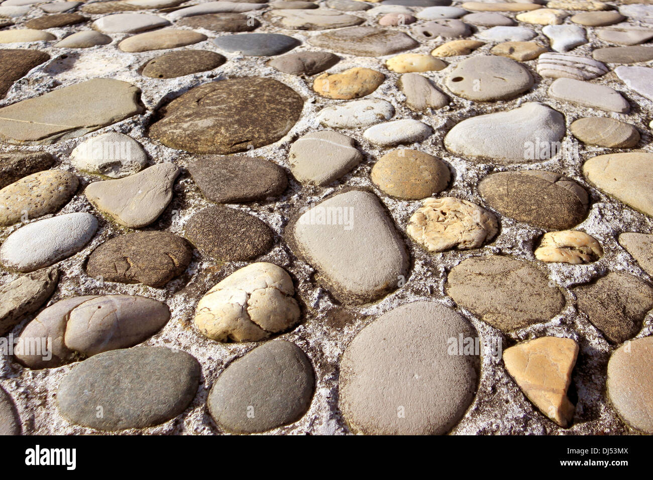 a wall texture stone shaped pebbles in concrete Stock Photo