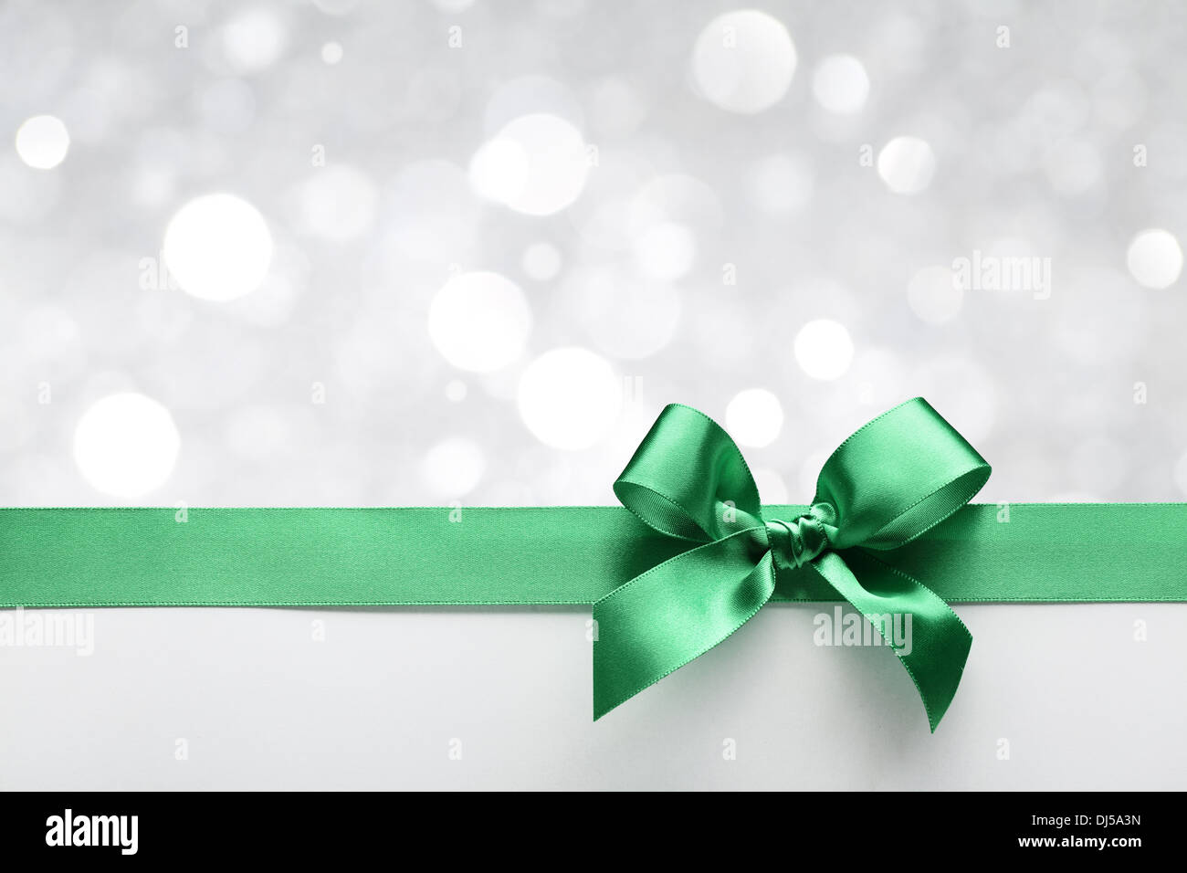 Green ribbon bow with bokeh,Christmas decoration. Stock Photo