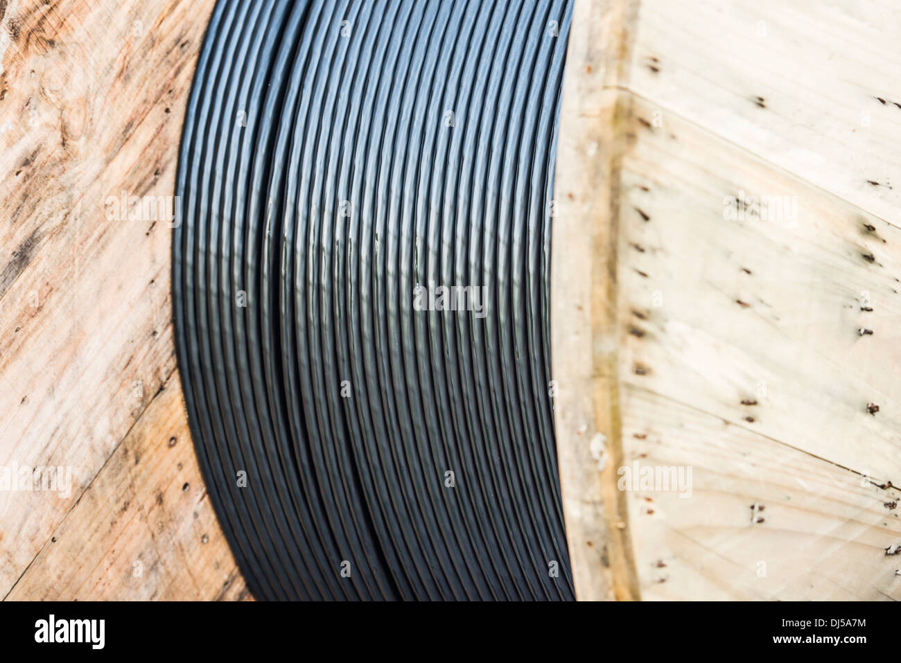 Fiber optic cable on a large wooden spool Stock Photo