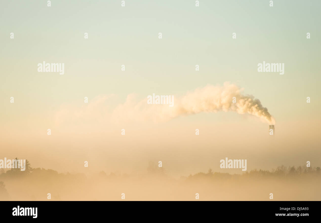 Nature scenery with industry smoke stack polluting the air. Sky with copy space. Stock Photo