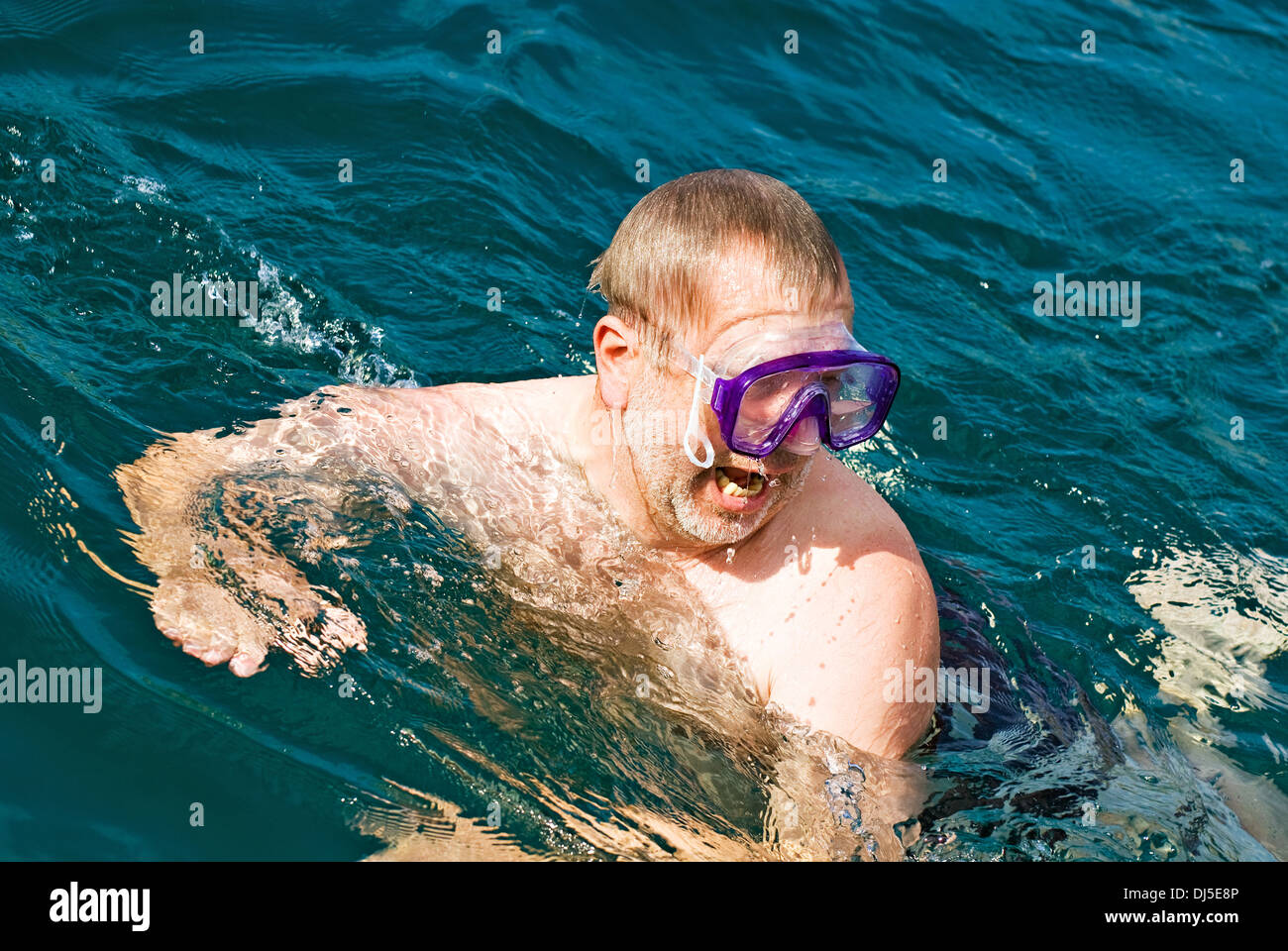 Man, 50 plus swims with goggles Stock Photo