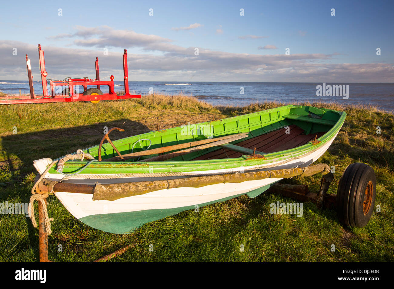 Fishing boats and a boat launcher on the coast at Boulmer ...