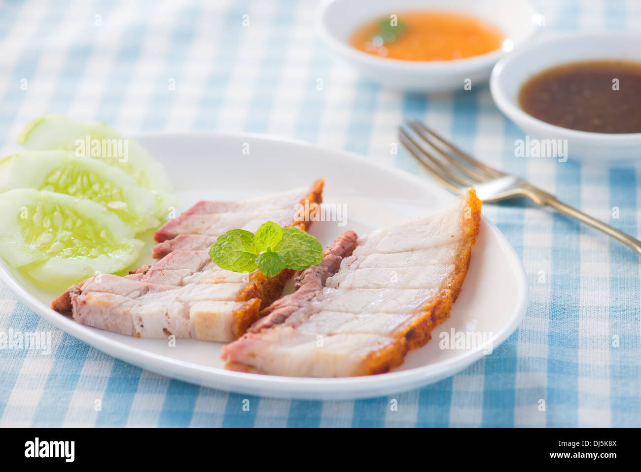 Siu Yuk - Chinese roasted pork served with soy and hoisin sauce. Stock Photo