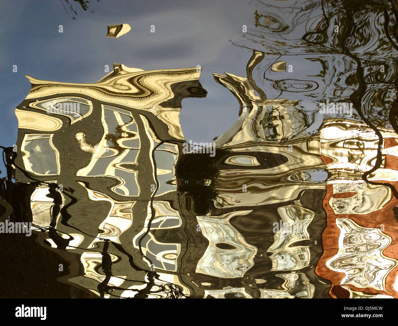 Reflections of buildings in Amsterdam on the calm canal water Stock Photo